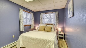 A bedroom with a bed, two bedside tables, a nightstand, a window with curtains, and a wall-mounted painting. - Montour Falls Apartment ~ 3 Mi to Seneca Lake! (Montour Falls)