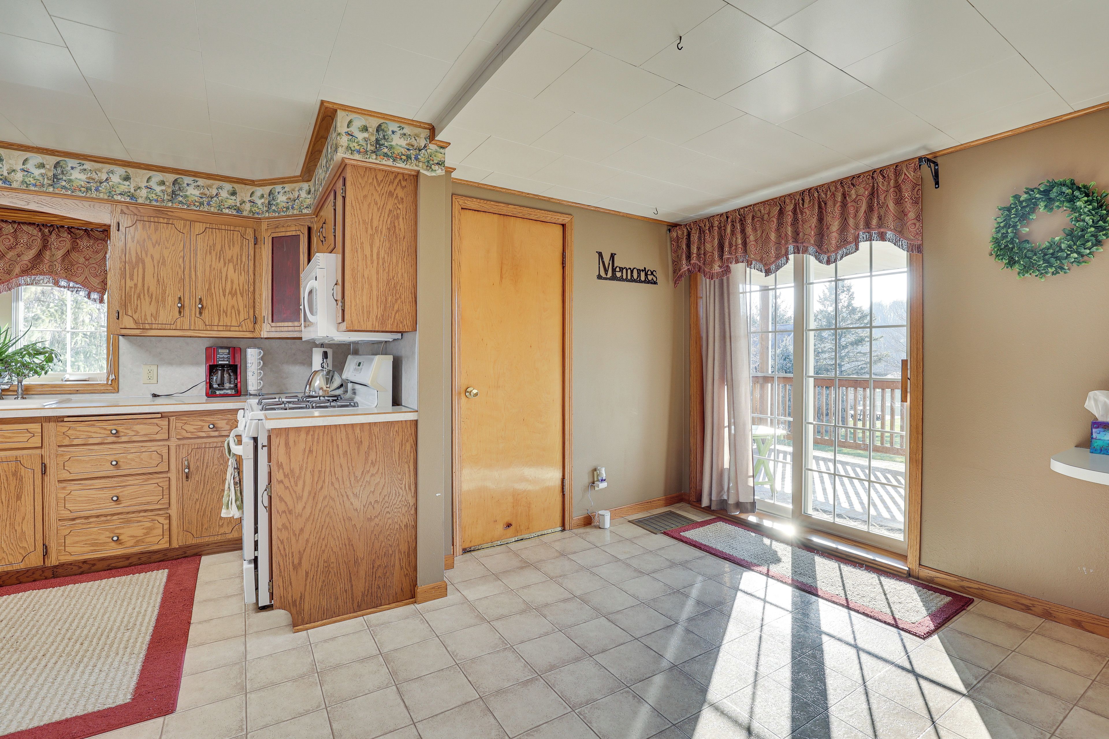 A kitchen with wooden cabinets, a microwave, and a coffee maker.