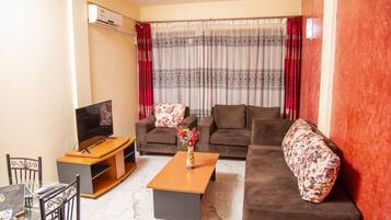 Superior Apartment | Living area | 42-inch flat-screen TV with satellite channels