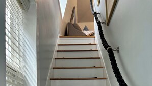A staircase with white walls, wooden steps, and black handrails. - The Ogunquit Getaway - 177 Shore Road (Ogunquit)