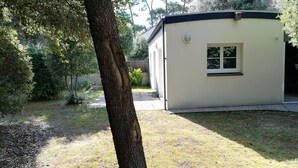 A small, single-story building with a flat roof, a door, and a window.