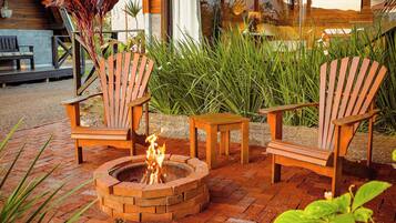 Un hogar con sillas y una mesa en un jardín.