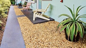 A building with a covered outdoor area, a fire extinguisher on the wall, and a pathway leading to the entrance. - Wilton Manors 2BR Charm! Walk to the Drive (Wilton Manors)