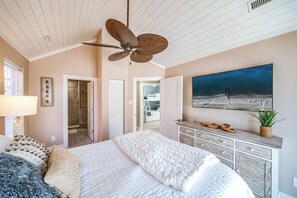 A bedroom with a large bed, a ceiling fan, a beach view painting, and a walk-in closet. - Beach Block In OCNJ between 7th & 8th St! - 3 Bd/2 Bath, Sleeps 10 (Ocean City)
