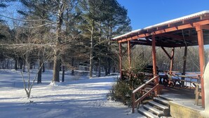 A covered outdoor area with a wooden structure, steps, and benches. - Domehouse DoverTN, near KY lake w event room, creek, pond & 4a fee hunting land. (Dover)