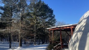 A snow-covered outdoor area with a wooden gazebo and a large snowbank. - Domehouse DoverTN, near KY lake w event room, creek, pond & 4a fee hunting land. (Dover)