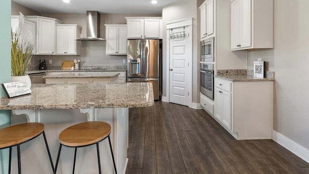 A modern kitchen with white cabinets, stainless steel appliances, and a granite countertop. - THe Pirates Hideout - slide•gameroom•ada•elevator•rockwall (Pensacola)