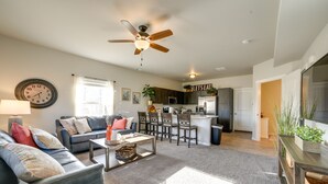 A modern living room with a sofa, coffee table, and a ceiling fan. - Colorado Springs Family Home ~ 10 Mi to Downtown! (Colorado Springs)