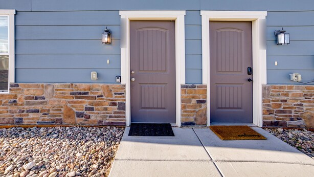 A house with two front doors, a stone foundation, and a concrete walkway leading to the entrance. - Colorado Springs Family Home ~ 10 Mi to Downtown! (Colorado Springs)