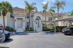 Stunning two-story building with a central entrance and palm trees in the front.