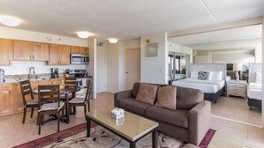 A compact living space with a kitchenette, a dining area, a sofa, and a bedroom. - Ocean View Waikiki Condo with Free Parking -- Short Walk to Beach (Honolulu)