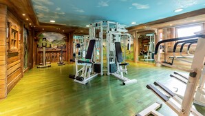 A gym with wooden walls, ceiling murals, and various exercise equipment. - Apartment 'Lapon H10' with Mountain View and Balcony (Hauteluce)