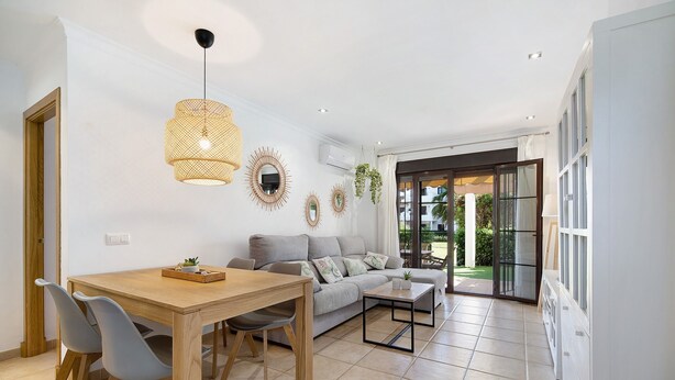 A modern living room with a dining area, a sofa, and a coffee table.