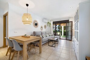 A modern living room with a dining area, a sofa, and a coffee table.