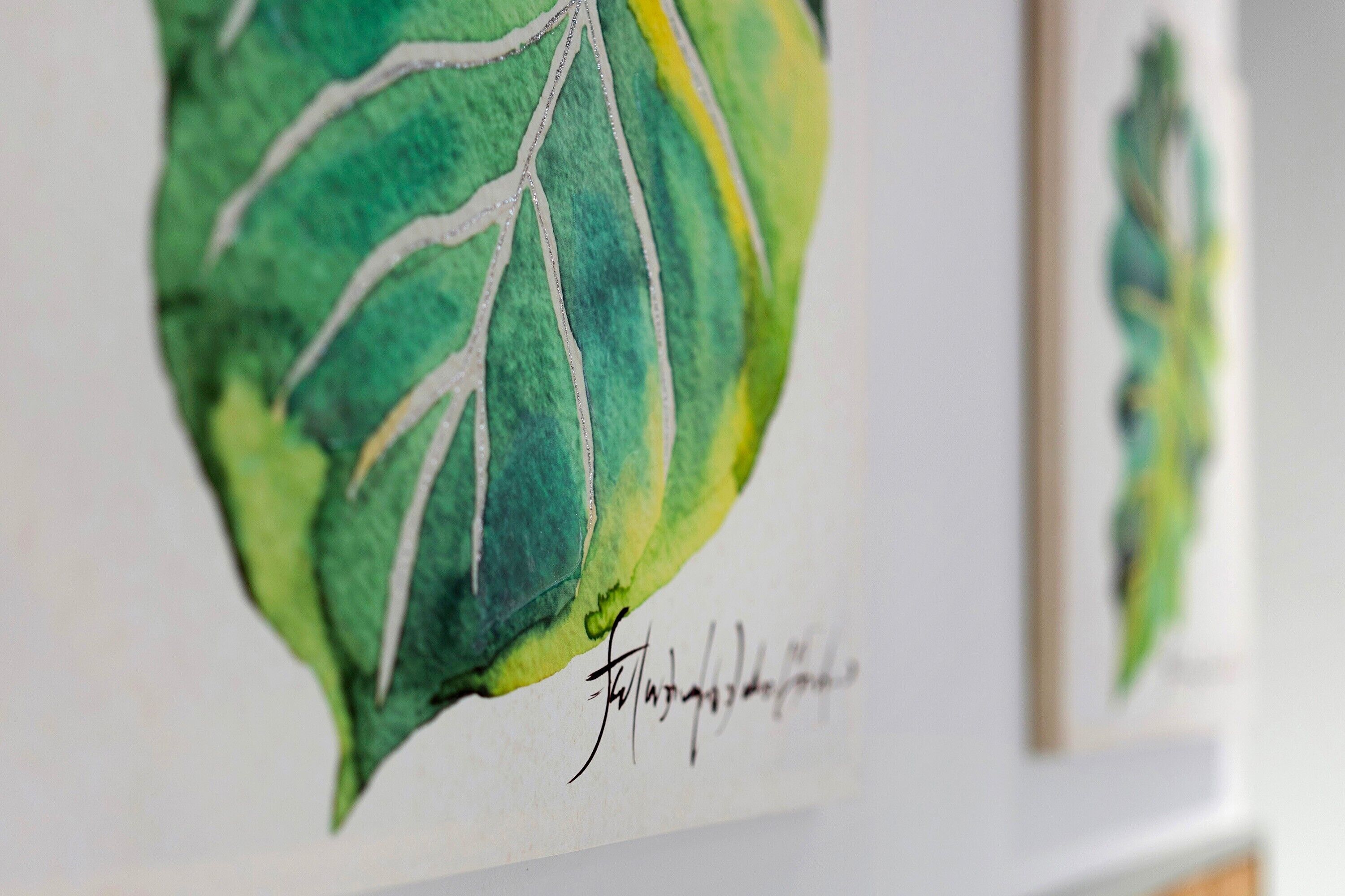 Ein Detailaufnahme eines Aquarellgemäldes mit einer Unterschrift.