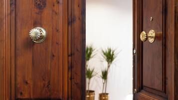 A wooden door with a brass handle and a brass lock.