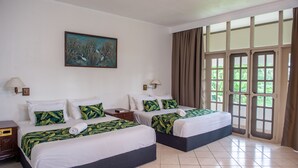 A hotel room with two beds, a painting on the wall, and a large window with curtains. - Yatu Lau Lagoon Resort  (Pacific Harbour)