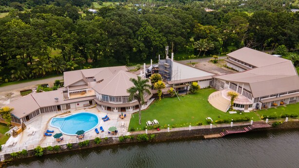 A large resort with a swimming pool, multiple buildings, and a surrounding lush landscape. - Yatu Lau Lagoon Resort  (Pacific Harbour)
