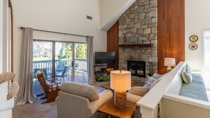 A cozy living room with a stone fireplace, a television, and comfortable seating. - Chetola Chestnut 8 - close to downtown Blowing Rock! (Blowing Rock)