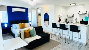 A modern apartment with a living area, a kitchenette, and a bedroom. - Condado Oasis on Ashford Ave: Oceanview and Pool (San Juan)