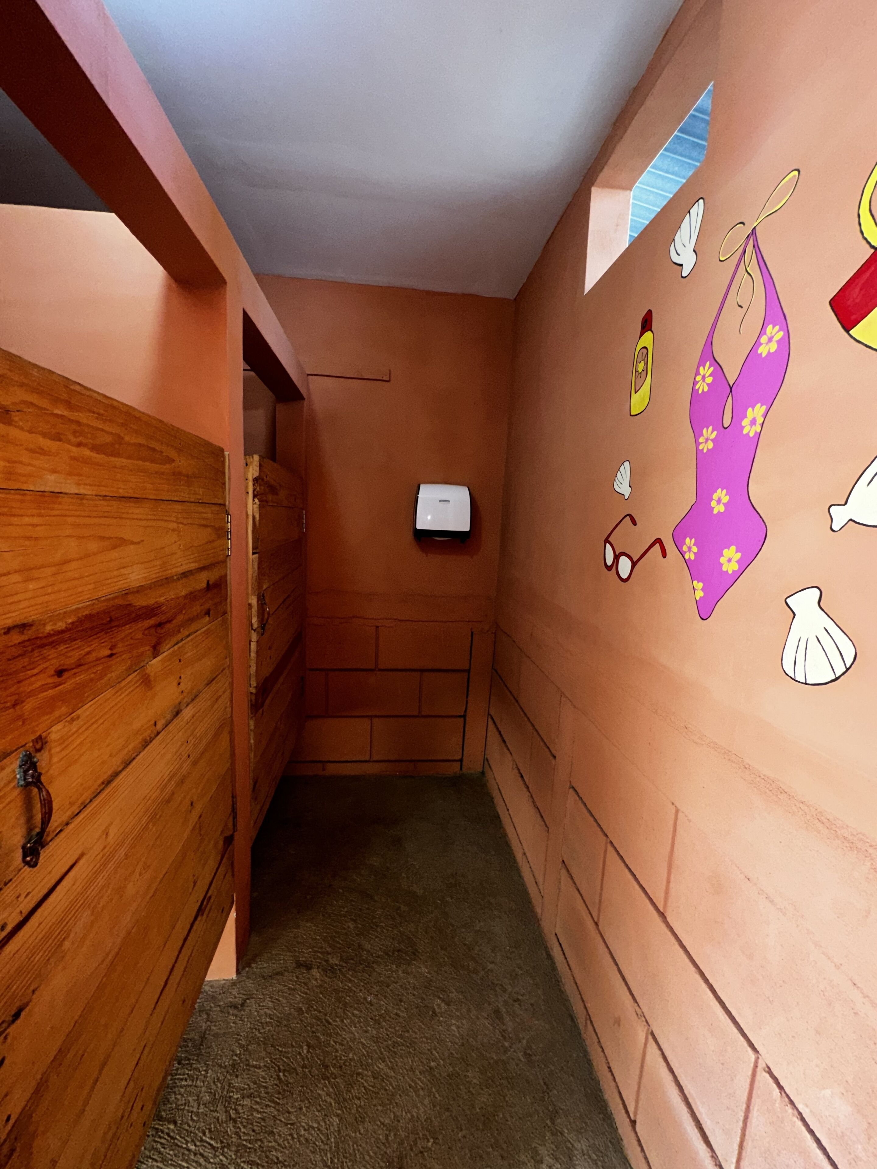 A narrow hallway with wooden walls and a carpeted floor.