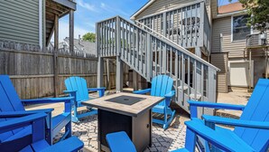 A backyard with blue Adirondack chairs, a small table, and a wooden deck with a staircase. - Professionally Managed | 3 Blocks to Beach (Seaside Heights)