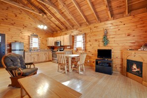 A cozy cabin-style kitchen with wooden walls and a high ceiling. - Moonlight Ridge Cabin | Hocking Hills, 200 Acres (South Bloomingville)