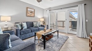 A modern living room with a sofa, armchairs, a coffee table, and a ceiling fan. - La Mirage Condo 214 Beachfront Resort Condominiums with Private Boardwalk (Port Aransas)
