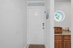 A white door with a sign above it reading 'Leaside Sanctuary.' - La Mirage Condo 323 Beachfront Resort Condominiums with Private Boardwalk (Port Aransas)