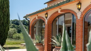 A building with arched windows and a brick facade. - Le Cascate by Interhome (Saturnia)
