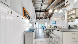 A kitchen with white cabinetry, a central island, and pendant lighting. - Pet Friendly! Private Beach Access! Chateau La Mer 8C Destin! (Destin)