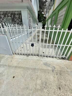Secure entrance to a residence with a gated pathway.