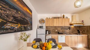 A modern kitchen with wooden cabinets, a microwave, and a coffee machine. - Vacation home Ulika by Interhome (Poreč/Baderna)