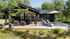 A modern house with a covered patio, outdoor seating, and a deck. - "Ela" - 800m from the sea by Interhome (Vig)