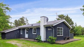 A single-story house with a dark exterior, a chimney, and a small porch. - "Ylvi" - 2.8km from the sea by Interhome (Rømø)
