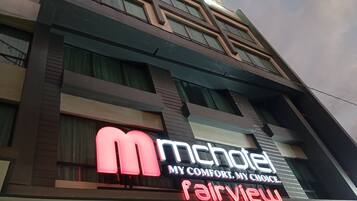 A hotel sign with 'mchotel' and 'fairview' branding, indicating the hotel name and possibly a sub-brand or location.