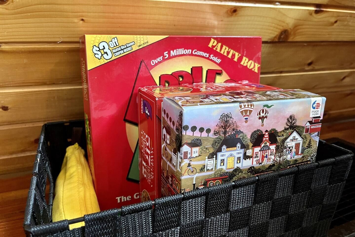 A box of Party Box games in a black basket.