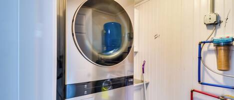 A laundry area with a front-loading washing machine and a dryer.