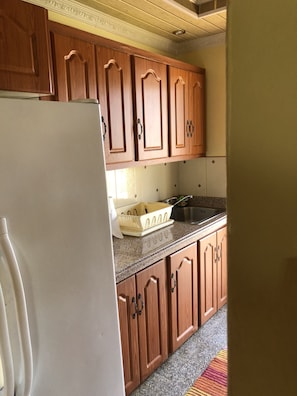 Fridge, microwave, cookware/dishes/utensils, dining tables