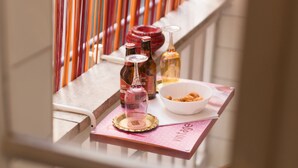 A balcony with a table set for a meal, featuring bottles and glasses. - 3 DOUBLE ROOMS IN THE CENTER OF ROME! (Roma)