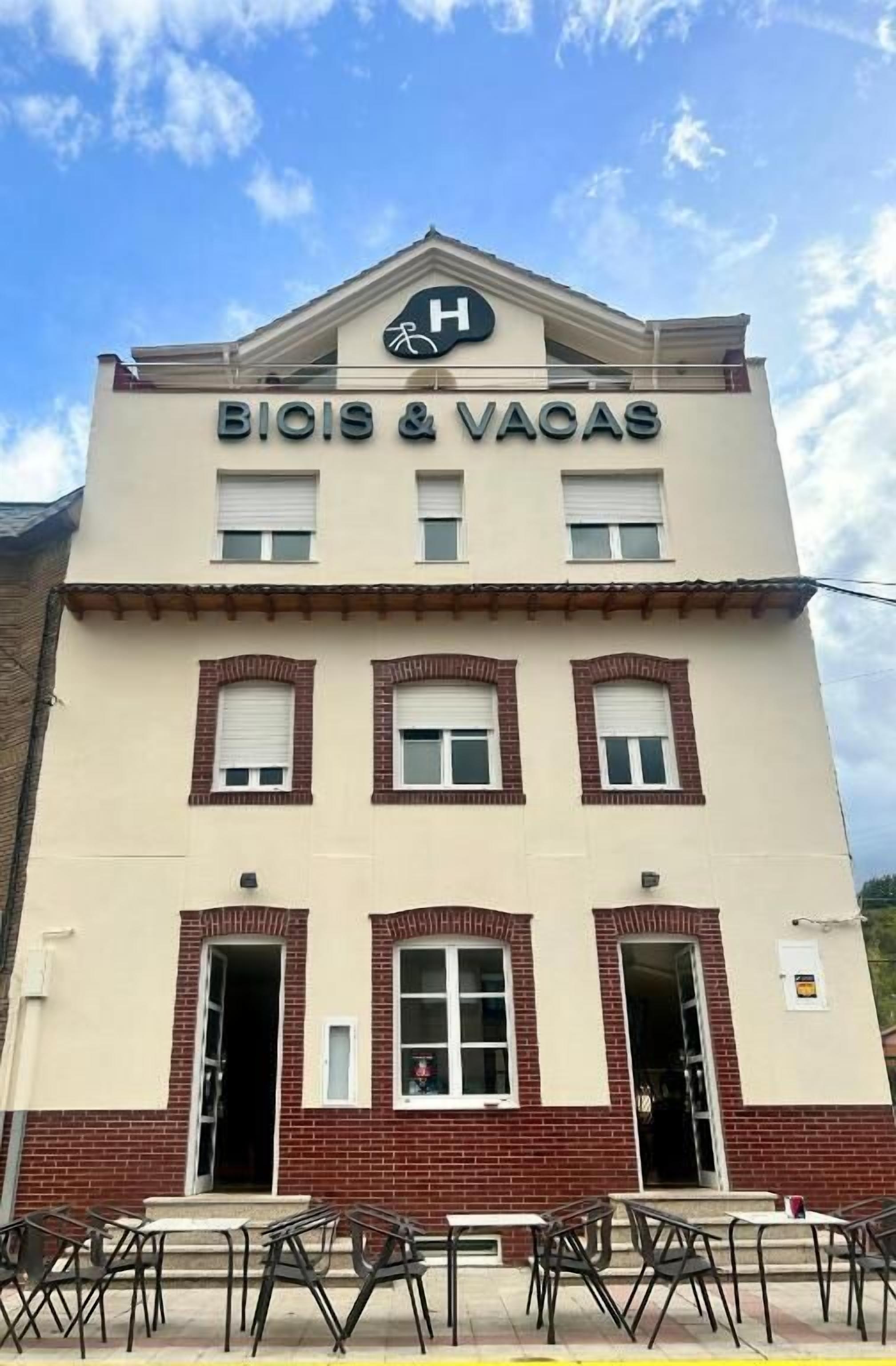 Een gebouw met een bord waarop 'BIOIS & VACAS' staat en een logo met een 'H' erboven.