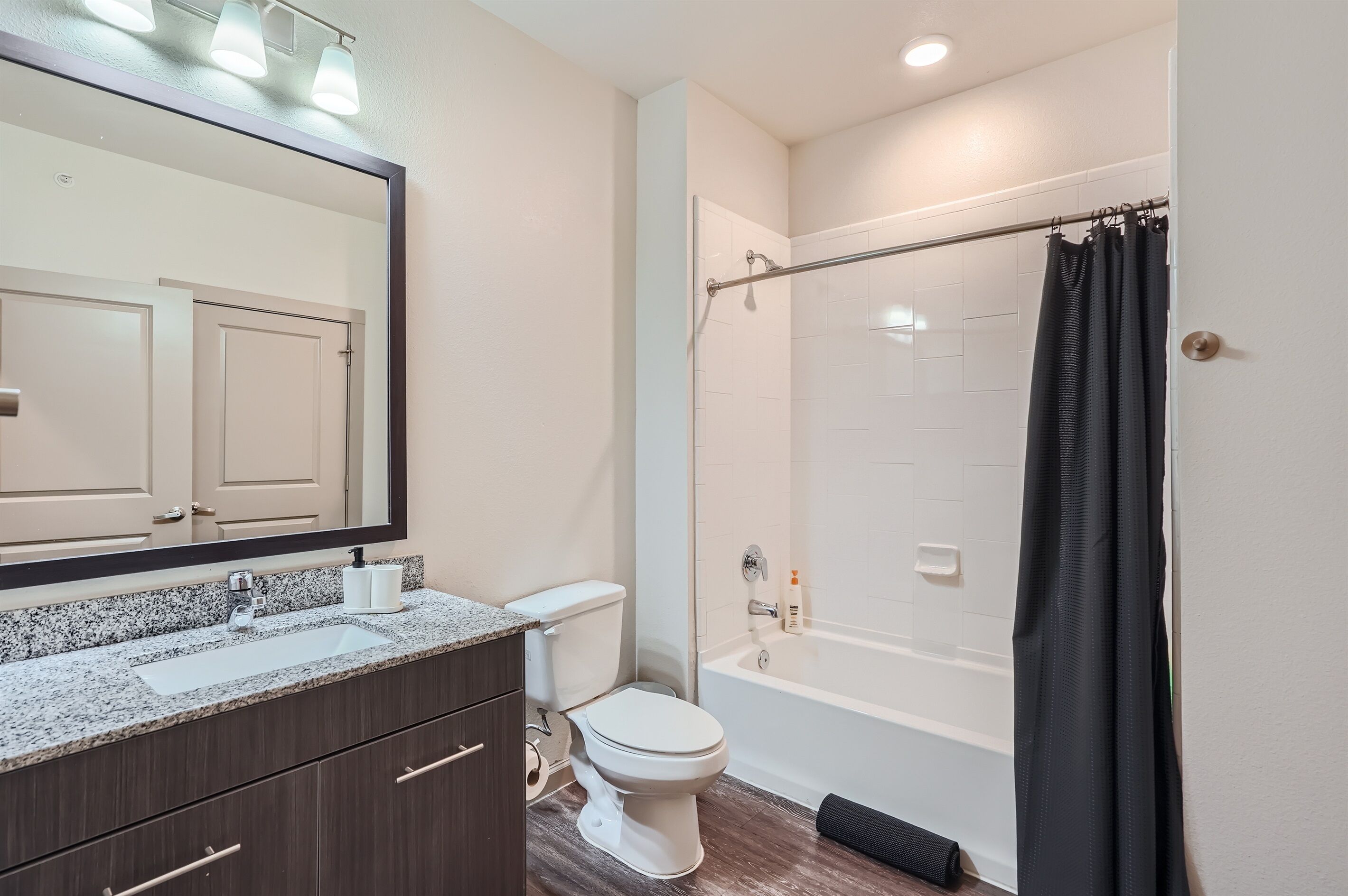A bathroom with a sink, toilet, and bathtub.