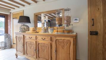 A wooden cabinet with drawers and a mirror above it.