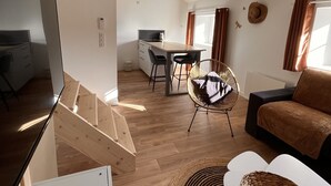 Un intérieur moderne comprenant un coin repas, une cuisine et un espace salon.