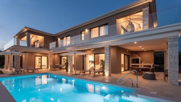A modern two-story house with a swimming pool, outdoor seating, and a balcony. - Beautiful home in Kastelir with sauna (Kastelir)