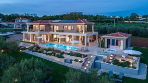A two-story house with a swimming pool, outdoor seating, and solar panels. - Beautiful home in Kastelir with sauna (Kastelir)