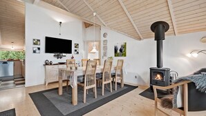 A modern interior with a dining area, kitchen, and a wood-burning stove. - Awesome home in Ulfborg with kitchen (Ulfborg)