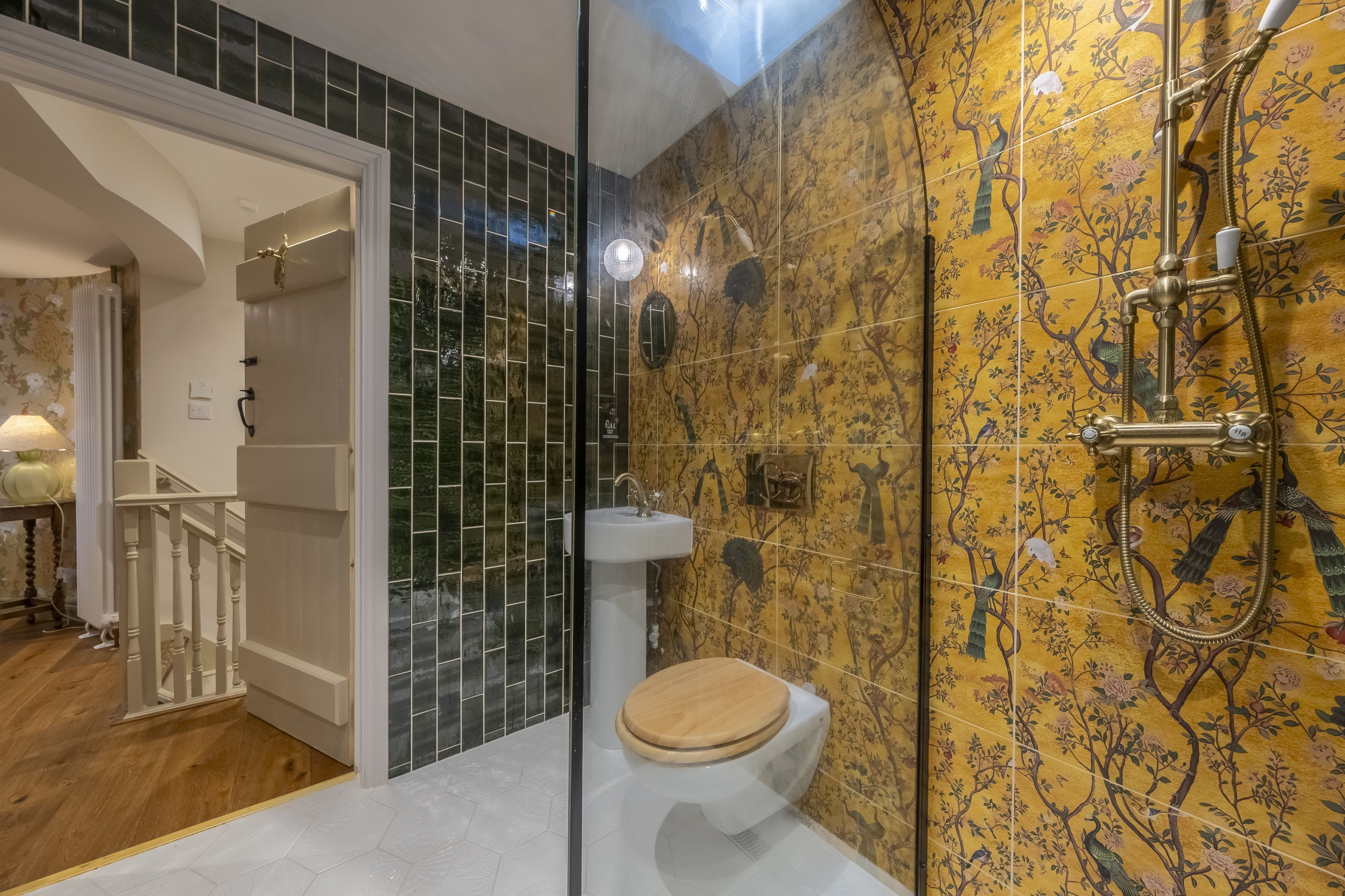 A bathroom with a shower, toilet, and sink.