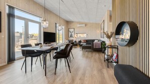A spacious living area with a dining table, sofas, and a fireplace. - Pet friendly home in Hemmet with WiFi (Hemmet)