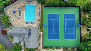 An aerial view of a property with a swimming pool, tennis courts, and a building with a sloped roof. - 5 BR - 3 BA <2 Primary BR> SLEEPS 10 - 3 Pools - Linens & Bath Towels Provided (Rehoboth Beach)